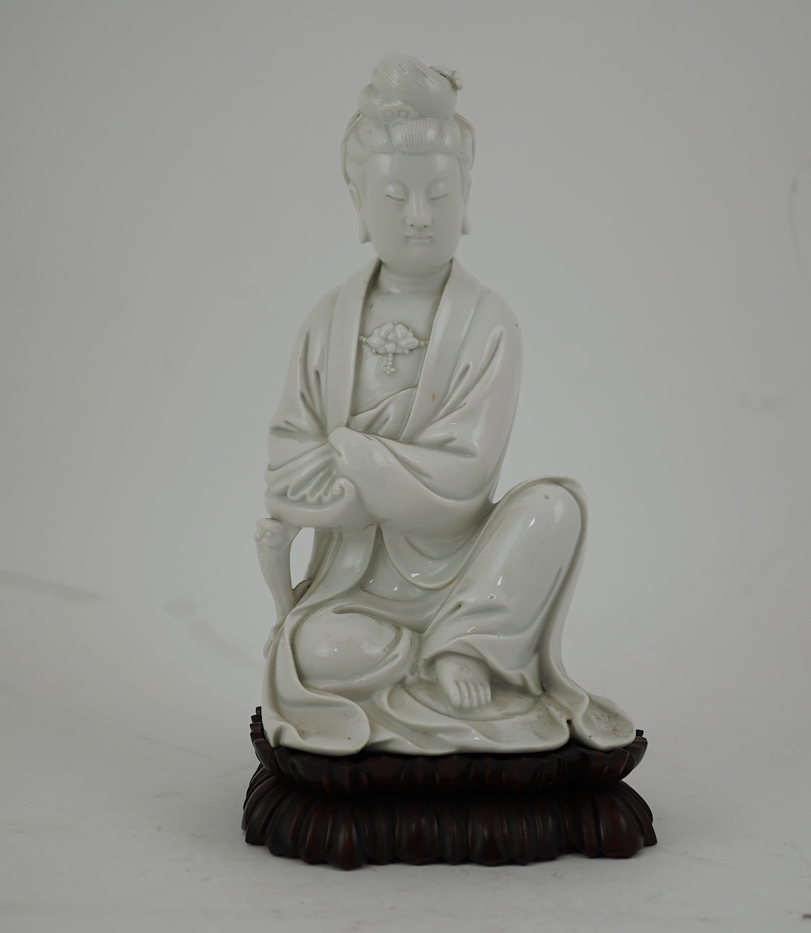 A Chinese blanc-de-chine seated figure of Guanyin, late 19th/early 20th century